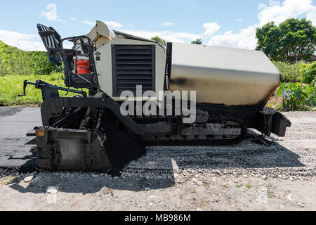 Asphalt road paver paving machine construction industry roadwork repair Stock Photo