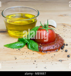 Ketchup tomato basil olive oil herbs garlic board black pepper ingredients square. Stock Photo