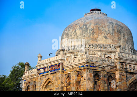 Beautiful Shish Gumbad, constructed 1489-1517 is a tomb in the Lodhi Gardens, New Delhi. Domed mosque with blue sky background Stock Photo