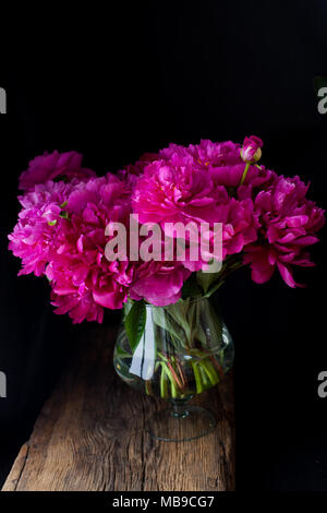 burgundy, red, bright red peonies - bouquet on a black background Stock Photo