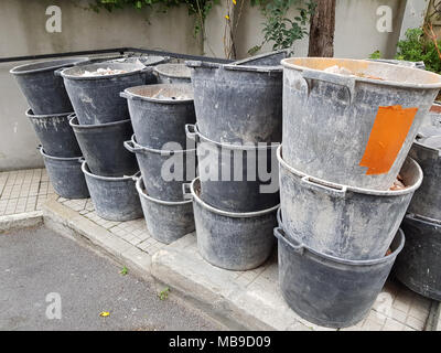 Pile of plastic construction buckets on construction site background, Construction site, home renovation. Stock Photo
