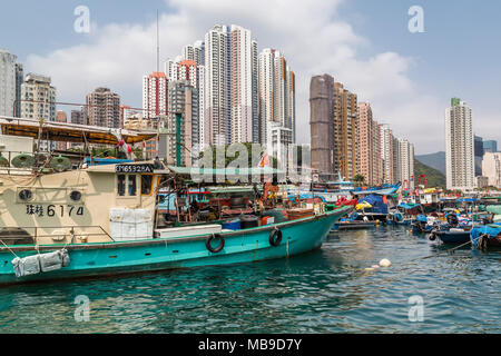 High rise buildings provide a backdrop for fishing boats in Aberdeen Harbour, Hong Kong. Stock Photo
