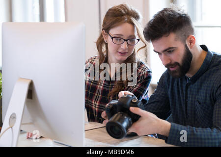 Two young designers working in modern office Stock Photo
