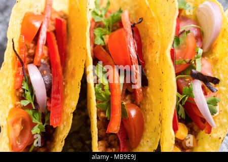 Three Pork Tacos in Shells on Stone Background Stock Photo