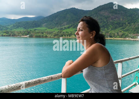 Tourist woman looking at sea view from boat Stock Photo