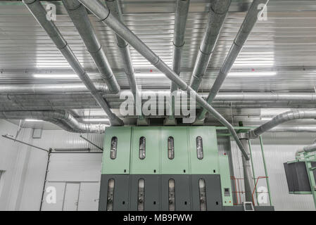 Industrial metal pipes along the ceiling, ventilation system Stock Photo