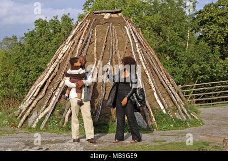 STOCKHOLM, SWEDEN - OCTOBER 01, 2006: Unidentified people near old hovel in Skansen, Stockholm, Sweden. Sami lived in the tents that covered the peat, Stock Photo