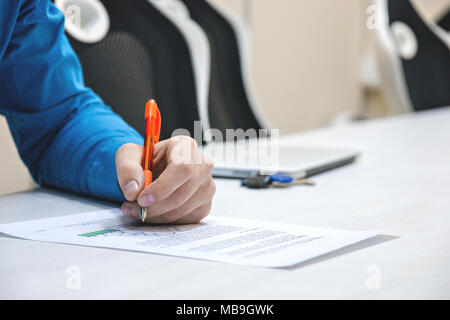 Analyzing charts and reports.The person checks the data in the report. Work concept. Work in the office and at home. Stock Photo