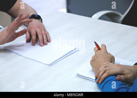 Male applicant having job interview, employers reading resume, asking question. Stock Photo