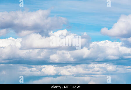 Blue sky background with fluffy huge clouds Stock Photo