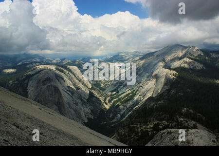 Typical view of Yosemite National Park, shot taken from the top of Half Dome which was reached rock climbing up snake dike. Stock Photo
