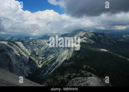 Typical view of Yosemite National Park, shot taken from the top of Half Dome which was reached rock climbing up snake dike. Stock Photo