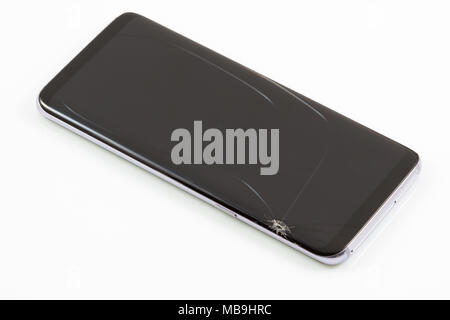 New and modern smartphone with screen has cracks, Touch screen smartphone with broken screen isolated on white background, with clipping path. Stock Photo
