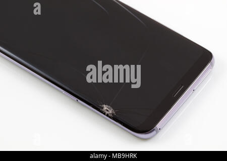 New and modern smartphone with screen has cracks, Touch screen smartphone with broken screen isolated on white background, with clipping path. Stock Photo