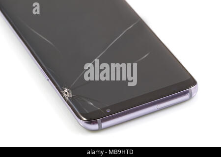 Black modern & new touch screen smartphone with broken screen isolated on white background. Stock Photo