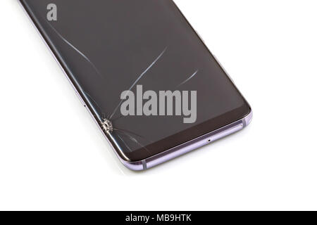 New and modern smartphone with screen has cracks, Touch screen smartphone with broken screen isolated on white background, with clipping path. Stock Photo