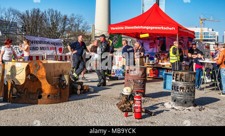 Germany Berlin, Mitte, 8th April 2018. Berlin Firefighters oppose austerity policies of state government in ‘Berlin Burns’ demonstration in Front of the Red Town Hall Firefighters are protesting about poor working conditions, lack of staff, old equipment and a recently introduced 12-hour shift system. A brazier carries their motto ’Berlin burns’ in a symbolic attempt to alert the public to the dangerous situation. The firefighters’ protest is directed against the Social Democratic-Left Party-Green Party coalition that runs the Berlin state government. credit: Eden Breitz/Alamy Live News Stock Photo