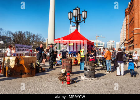 Germany Berlin, Mitte, 8th April 2018. Berlin Firefighters oppose austerity policies of state government in ‘Berlin Burns’ demonstration in Front of the Red Town Hall Firefighters are protesting about poor working conditions, lack of staff, old equipment and a recently introduced 12-hour shift system. A brazier carries their motto ’Berlin burns’ in a symbolic attempt to alert the public to the dangerous situation. The firefighters’ protest is directed against the Social Democratic-Left Party-Green Party coalition that runs the Berlin state government. credit: Eden Breitz/Alamy Live News Stock Photo