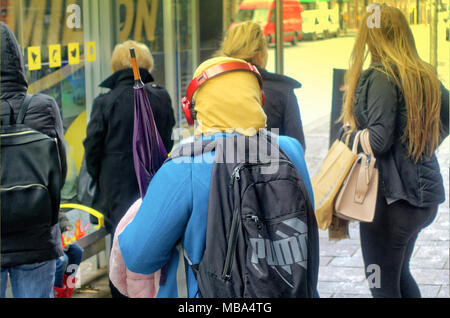 Glasgow, Scotland, UK 9th April. UK Weather: People shelter in a bus stop and a  brolly stays dry on a miserable wet day with squalid showers. Credit: gerard ferry/Alamy Live News Stock Photo