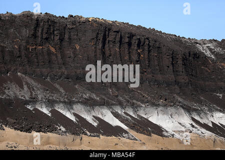 06 April 2018, Germany, Grevenbroich: A layer of brown coal above a layer of sand at the surface mining Garzweiler in the Rhenish lignite mining region. Photo: Oliver Berg/dpa Stock Photo