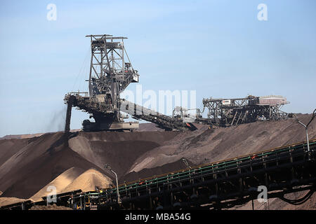 06 April 2018, Germany, Grevenbroich: A stacker of RWE Power transports soil at the surface mining Garzweiler in the Rhenish lignite mining region. Photo: Oliver Berg/dpa Stock Photo
