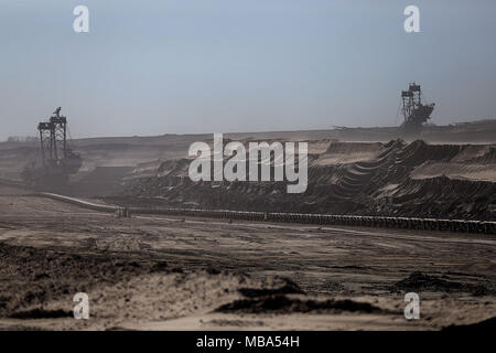 06 April 2018, Germany, Grevenbroich: Bucket wheel excavators mine brown coal at the surface mining Garzweiler in the Rhenish lignite mining region. Photo: Oliver Berg/dpa Stock Photo