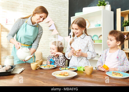 Adorable Family Having Tea Party Stock Photo