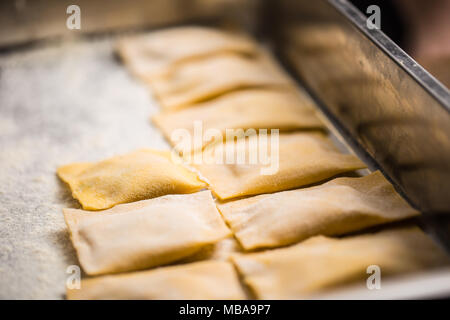 Uncooked hand-made Italian pasta ravioli ready for cooking. Stock Photo