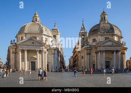 Tourists in the cobbled square Piazza del Popolo (translated from Italian literally meaning 'People's Square') with the 'twin' churches of Santa Maria Stock Photo