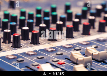 View of the mixing console in the Studio. Buttons, faders and sliders. Selective focus Stock Photo