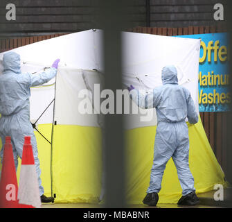 Forensic officers and a police tent at an Esso petrol station in Collier Row Road, Romford, east London, after a man has been shot dead by police after claiming he had a firearm. Stock Photo