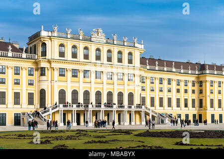 The garden park in Shonbrunn Palace (Wien) prepared for the winter with missing flowers and large groups of tourists walking around Stock Photo