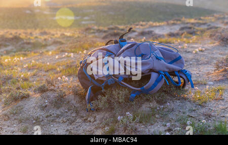 Professional hiking backpack lying on the ground Stock Photo