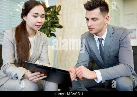 Young Colleagues Discussing Business Stock Photo