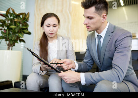 Young Businessman Talking to Colleague Stock Photo