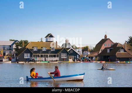 Thorpeness Suffolk lake, people enjoy a sunny afternoon boating on the lake in the centre of Thorpeness known as The Meare, Suffolk, England, UK. Stock Photo