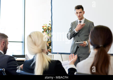 Business Coach Giving Speech in Forum Stock Photo