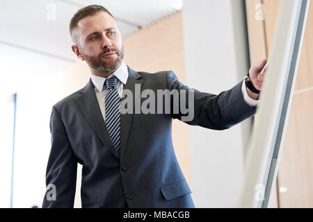 Successful Businessman at Whiteboard Stock Photo