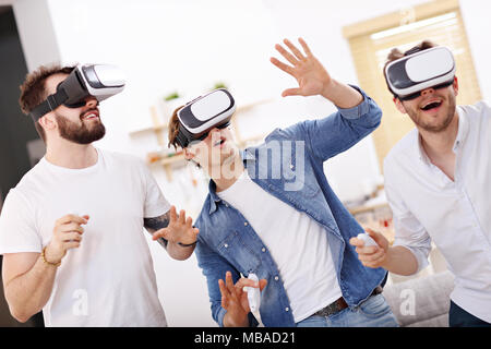 Friends having fun on the couch with video games Stock Photo