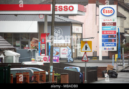 Forensic officers at an Esso petrol station in Collier Row Road, Romford, east London, after a man has been shot dead by police after claiming he had a firearm. Stock Photo