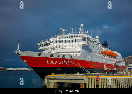 ALESUND, NORWAY - APRIL 04, 2018: Outdoor view of Hurtigruten coastal vessel KONG HARALD, is a daily passenger and freight shipping service along Norway's coast between Bergen and Kirkenes Stock Photo