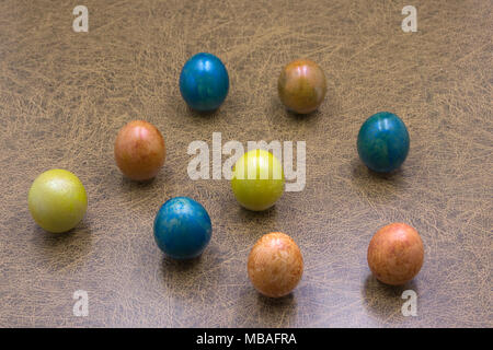 Easter colored colored eggs arranged on a white plate in a circle of color palette isolate Stock Photo