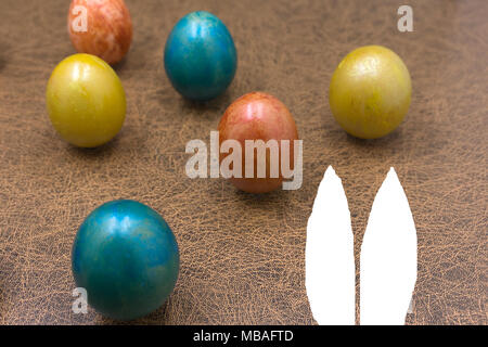 Easter holiday concept with cute handmade eggs, bunny, chicks and party hats Stock Photo