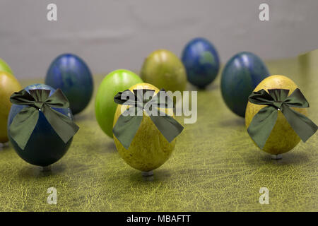 Group of colorful candy Easter eggs wrapped in foil with bow Stock Photo