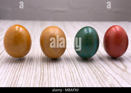 Multi-colored eggs on the nest with orange light side for easter holiday background Stock Photo