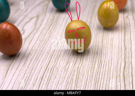 EASTER. Font Easter theme. Designer stocking from Easter colored eggs with colorful ribbons on a wooden table Stock Photo