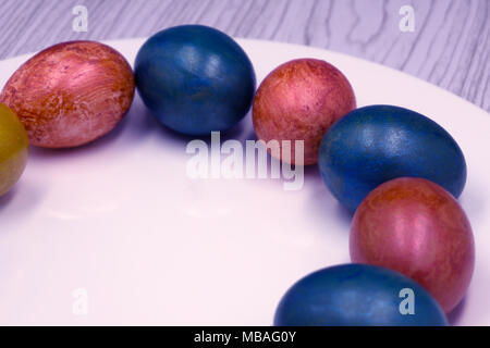 Basket with easter cake and red eggs on rustic wooden table. Top view Stock Photo