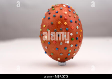 Elegant gold and silver bejeweled egg-shaped ornament with gold mesh bow includes clipping path Stock Photo