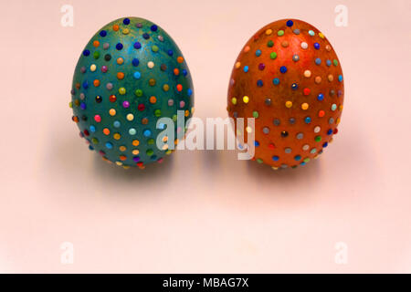 Decorated Easter eggs in a bowl, closeup on pastel background Stock Photo
