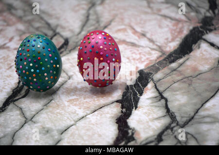 Easter symbol in green color near eggs with beads. Happy holiday concept. Easter decor: basket with collection of painted and decorated eggs. Basket f Stock Photo